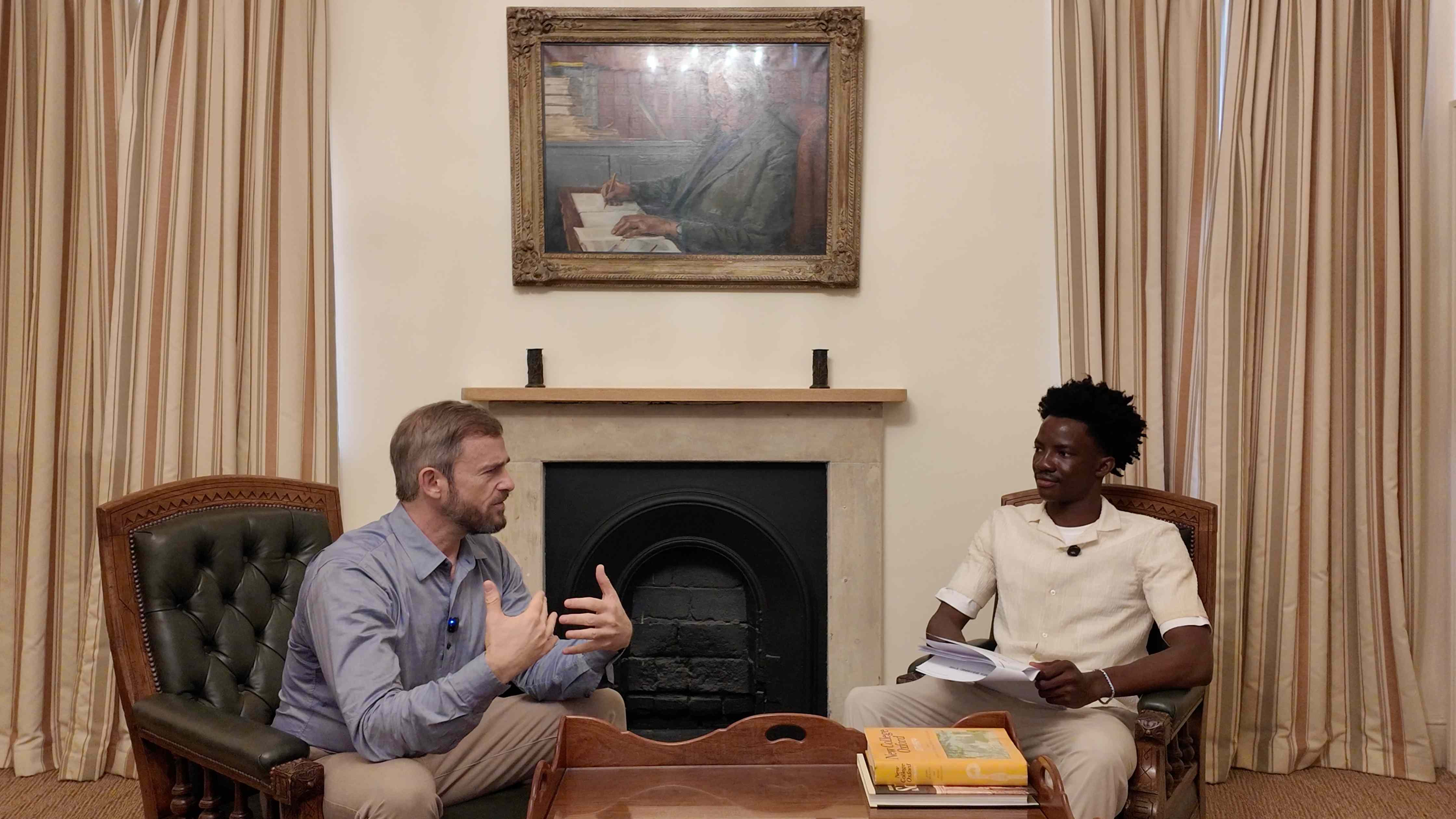 Joe Ross in conversation with Iyioluwa Adesan, Founder and CEO of Apprentis, seated by a fireplace
