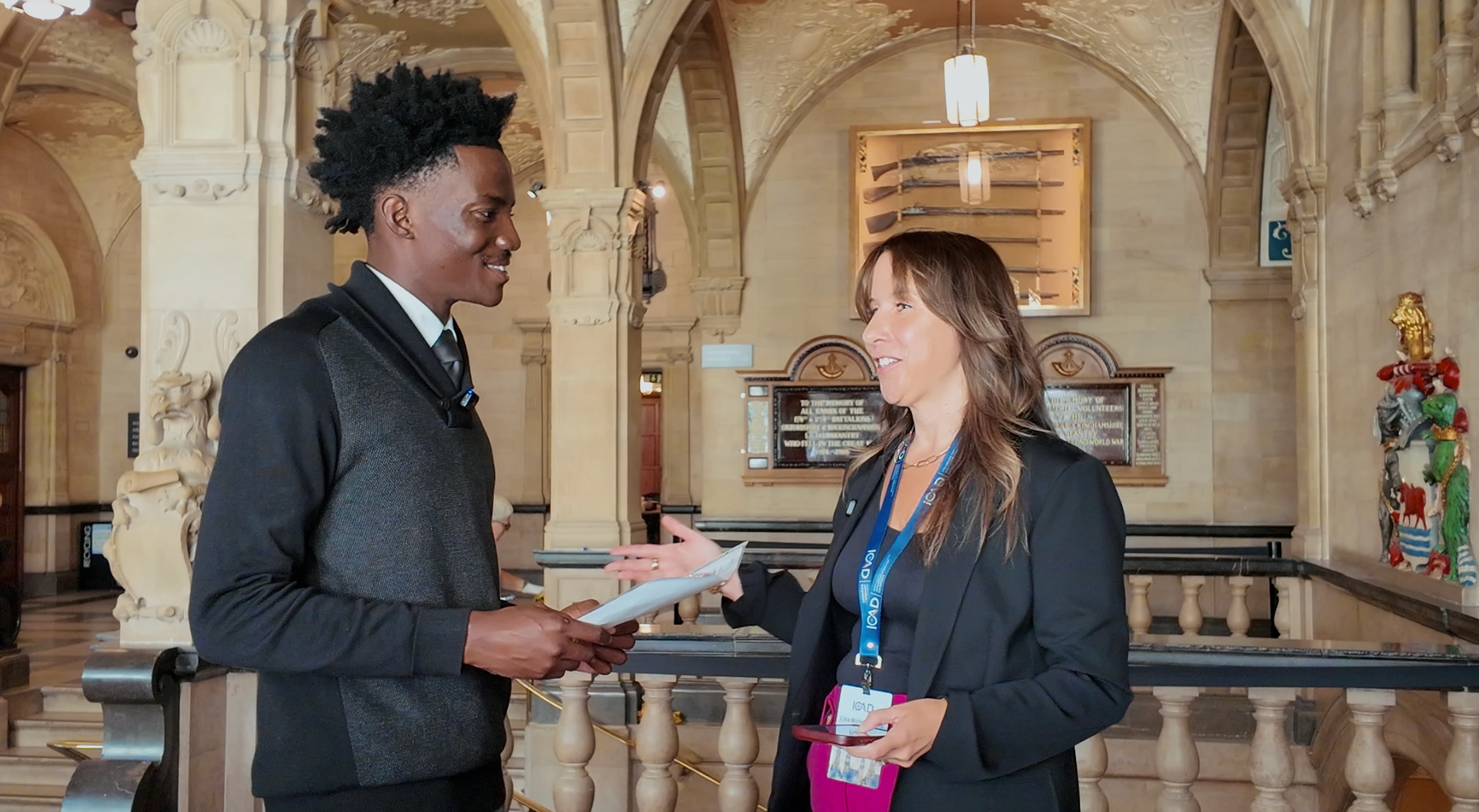 Lisa McIntyre-Hite in conversation with Iyioluwa Adesan, Founder and CEO of Apprentis, in an ornate stone hall